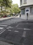 Les dalles de la guillotine affleurant dans la chaussée de la rue de la Croix-Faubin, avec la plaque de rue et le panneau Histoire de Paris